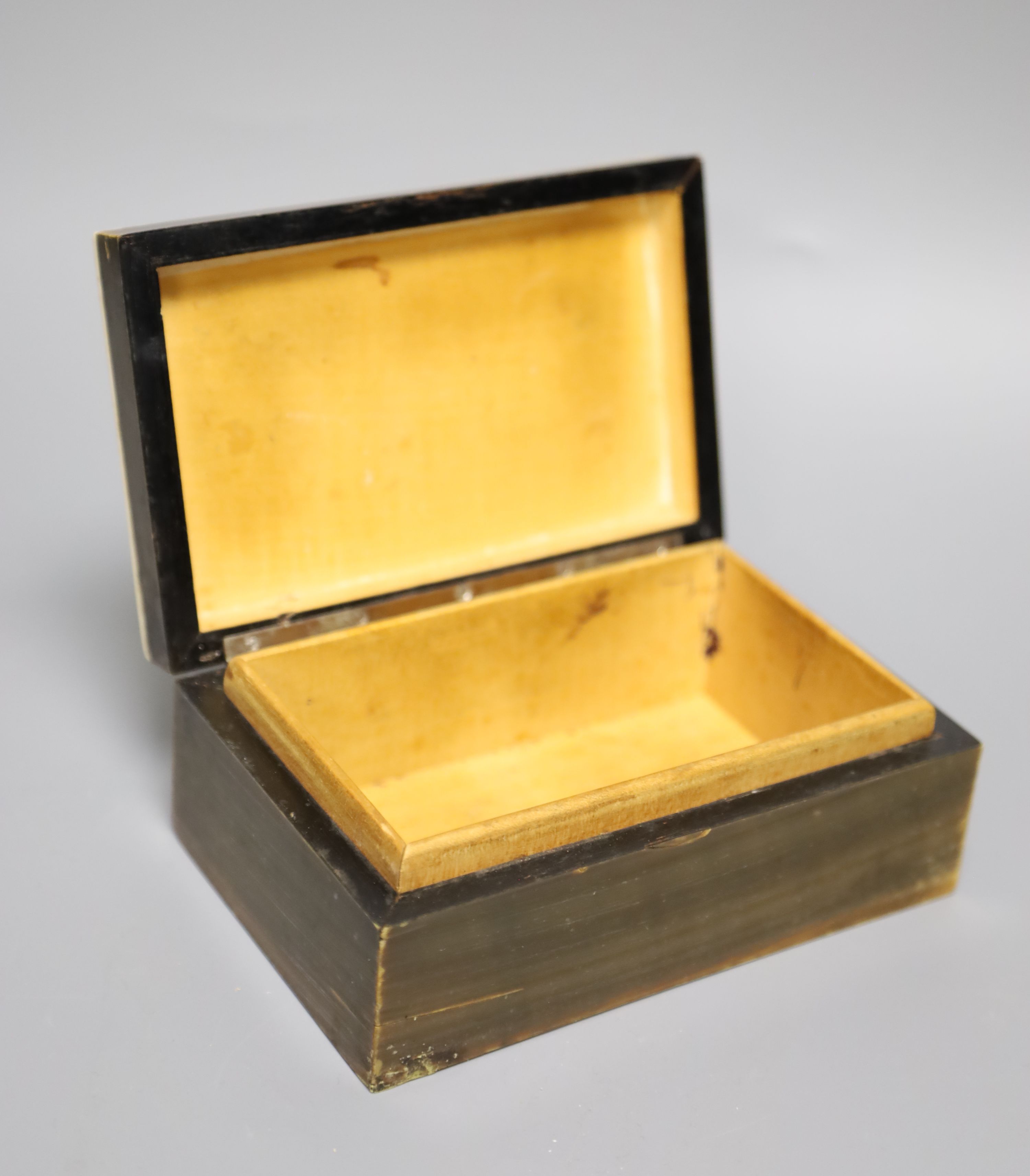 A horn veneered cigarette box, a horn handled magnifying glass and a Trench art ashtray